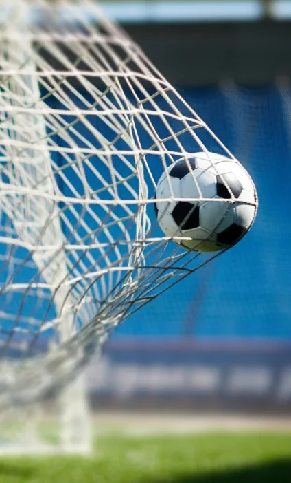 Soccer ball hitting the back of the net in a stadium, symbolizing a major acquisition. Global law firm Hogan Lovells advised Presidio on securing full ownership of Hellas Verona Football Club, marking a milestone in cross-border sports investment